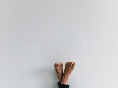 Focused balance pose with legs on a clean background.